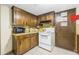 Kitchen featuring wood cabinets, white appliances, and tile floors at 3354 Wakefield Dr, Decatur, GA 30034