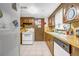 Kitchen featuring wood cabinets, white appliances, and tile floors at 3354 Wakefield Dr, Decatur, GA 30034