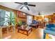 Comfortable living room featuring wood paneling, a brick fireplace, hardwood floors, and views into the kitchen at 3354 Wakefield Dr, Decatur, GA 30034