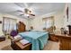 Spacious main bedroom featuring a ceiling fan, curtains, and carpeted floors at 3354 Wakefield Dr, Decatur, GA 30034