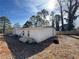 Home exterior shows white siding and a fenced yard space at 8859 Thomas Rd, Jonesboro, GA 30238