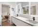 Modern primary bathroom featuring double sinks, sleek faucets, and bright lighting at 185 Pebble Trl, Alpharetta, GA 30009