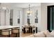 Cozy breakfast nook with a round table and stylish chairs, bathed in natural light from large windows at 185 Pebble Trl, Alpharetta, GA 30009