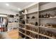 This walk-in closet features built in shelving and organization at 185 Pebble Trl, Alpharetta, GA 30009