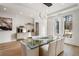 Bright dining room featuring a glass table, modern lighting and buffet with decor at 185 Pebble Trl, Alpharetta, GA 30009