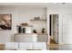 Dining room buffet with decorative accents, floating shelves and sleek white door at 185 Pebble Trl, Alpharetta, GA 30009