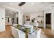 Open-concept dining room with glass table, modern lighting and butler's pantry at 185 Pebble Trl, Alpharetta, GA 30009