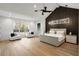 Expansive main bedroom with a vaulted ceiling, modern lighting, and wood accent wall at 185 Pebble Trl, Alpharetta, GA 30009