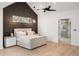 This main bedroom features paneled accent wall, light hardwood floors, and en suite bathroom at 185 Pebble Trl, Alpharetta, GA 30009