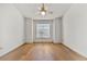 Well-lit bedroom featuring wood floors, a ceiling fan and a large window at 406 Vinings Forest Se Cir, Smyrna, GA 30080