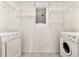 Bright laundry room with modern Bosch washer and dryer and wire shelving at 406 Vinings Forest Se Cir, Smyrna, GA 30080