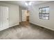 This empty bedroom has carpet floors and a view of nature from its window at 6090 Wintergreen Rd # 1A3, Norcross, GA 30093