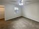 This is an empty bedroom with neutral-colored carpet and a window at 6090 Wintergreen Rd # 1A3, Norcross, GA 30093