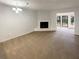 This spacious living room features a fireplace, neutral-colored carpet, and a ceiling light at 6090 Wintergreen Rd # 1A3, Norcross, GA 30093