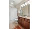 Standard bathroom including a tub, shower, sink and dark wood cabinets at 164 Owens Farm Ln, Woodstock, GA 30188