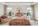 Cozy bedroom with patterned bedding, matching curtains, and bright natural light at 164 Owens Farm Ln, Woodstock, GA 30188