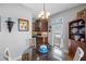 Cozy breakfast nook features a round glass table, and a view into the kitchen with dark wood cabinets and decor at 164 Owens Farm Ln, Woodstock, GA 30188