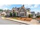 Exterior of community clubhouse with stone accents, well-maintained landscaping, and neutral color palette at 164 Owens Farm Ln, Woodstock, GA 30188