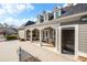 Outdoor patio with tables and chairs next to a clubhouse, offering a relaxing space at 164 Owens Farm Ln, Woodstock, GA 30188