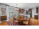 Formal dining room with hardwood floors, decorative rug, traditional furniture, and view to kitchen at 164 Owens Farm Ln, Woodstock, GA 30188