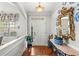 Inviting home entrance featuring hardwood floors, console table, and decorative mirror at 164 Owens Farm Ln, Woodstock, GA 30188