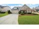 Charming home featuring a manicured lawn, two-car garage, and inviting curb appeal at 164 Owens Farm Ln, Woodstock, GA 30188