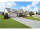 Well-maintained home with lush green lawn, concrete driveway and attached two car garage at 164 Owens Farm Ln, Woodstock, GA 30188