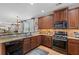 This kitchen features stainless steel appliances and wood cabinetry at 164 Owens Farm Ln, Woodstock, GA 30188