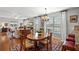 Open-concept living room and dining area featuring hardwood floors, neutral walls, and lots of natural light at 164 Owens Farm Ln, Woodstock, GA 30188