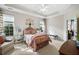 Bright main bedroom with tray ceilings, plush carpet, sitting area, and lots of natural light at 164 Owens Farm Ln, Woodstock, GA 30188