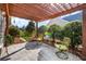 Cozy patio with wooden pergola and decorative outdoor seating at 164 Owens Farm Ln, Woodstock, GA 30188