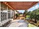 Covered patio with wooden pergola and bright outdoor seating at 164 Owens Farm Ln, Woodstock, GA 30188