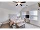 Bedroom with a decorative headboard, two windows and small desk with TV at 1721 Mcgarity Rd, Temple, GA 30179