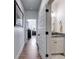 Hallway with a view to the bedroom and a half bathroom including granite countertops, white cabinetry and a decorative mirror at 1721 Mcgarity Rd, Temple, GA 30179