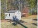 Outdoor shed with gray siding and an attached shelter for additional storage at 3410 Church Rd, Villa Rica, GA 30180