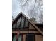 A-frame home with a unique window design and an American flag at 5435 Hearn Rd, Ellenwood, GA 30294