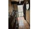 Hallway with tiled floor, shelving, and a view of the wooded outdoors at 5435 Hearn Rd, Ellenwood, GA 30294