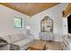 Cozy living room featuring a fireplace, wood ceiling and a decorative mirror at 462 Lakeshore Dr, Stockbridge, GA 30281