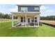 Outdoor covered patio with stone and furniture, surrounded by a well-maintained green lawn at 5760 Tillman Way, Powder Springs, GA 30127