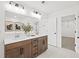 Bathroom featuring double sinks, shaker cabinetry, modern fixtures, and marble floors at 5760 Tillman Way, Powder Springs, GA 30127