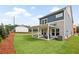 Beautiful backyard of home featuring a covered patio with outdoor seating and lush green lawn at 5760 Tillman Way, Powder Springs, GA 30127