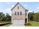 Beautiful new construction home featuring a two-car garage and a stone and white plank facade at 5760 Tillman Way, Powder Springs, GA 30127