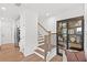 Hallway with a staircase, display cabinet and views of the kitchen at 5760 Tillman Way, Powder Springs, GA 30127