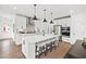 Bright, modern kitchen featuring stainless steel appliances, a large island and hardwood floors at 5760 Tillman Way, Powder Springs, GA 30127