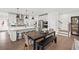 Modern kitchen with stainless steel appliances, white cabinets, hardwood floors and a dining table at 5760 Tillman Way, Powder Springs, GA 30127