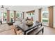 Open concept living room and dining area with hardwood floors and lots of natural light at 5760 Tillman Way, Powder Springs, GA 30127