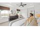 Well-lit main bedroom with a tray ceiling, large windows, and a view into the ensuite at 5760 Tillman Way, Powder Springs, GA 30127
