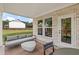 Covered patio with stone accents, stylish seating, and views of the spacious backyard at 5760 Tillman Way, Powder Springs, GA 30127