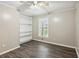Bright bedroom featuring stylish vinyl plank flooring, built in shelving, and a ceiling fan at 3113 Melissa Ct, Douglasville, GA 30135
