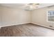 Cozy bedroom featuring a modern ceiling fan and large windows with hardwood floors at 3113 Melissa Ct, Douglasville, GA 30135